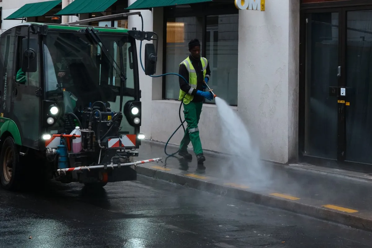 Operator pressure washing a commercial sidewalk