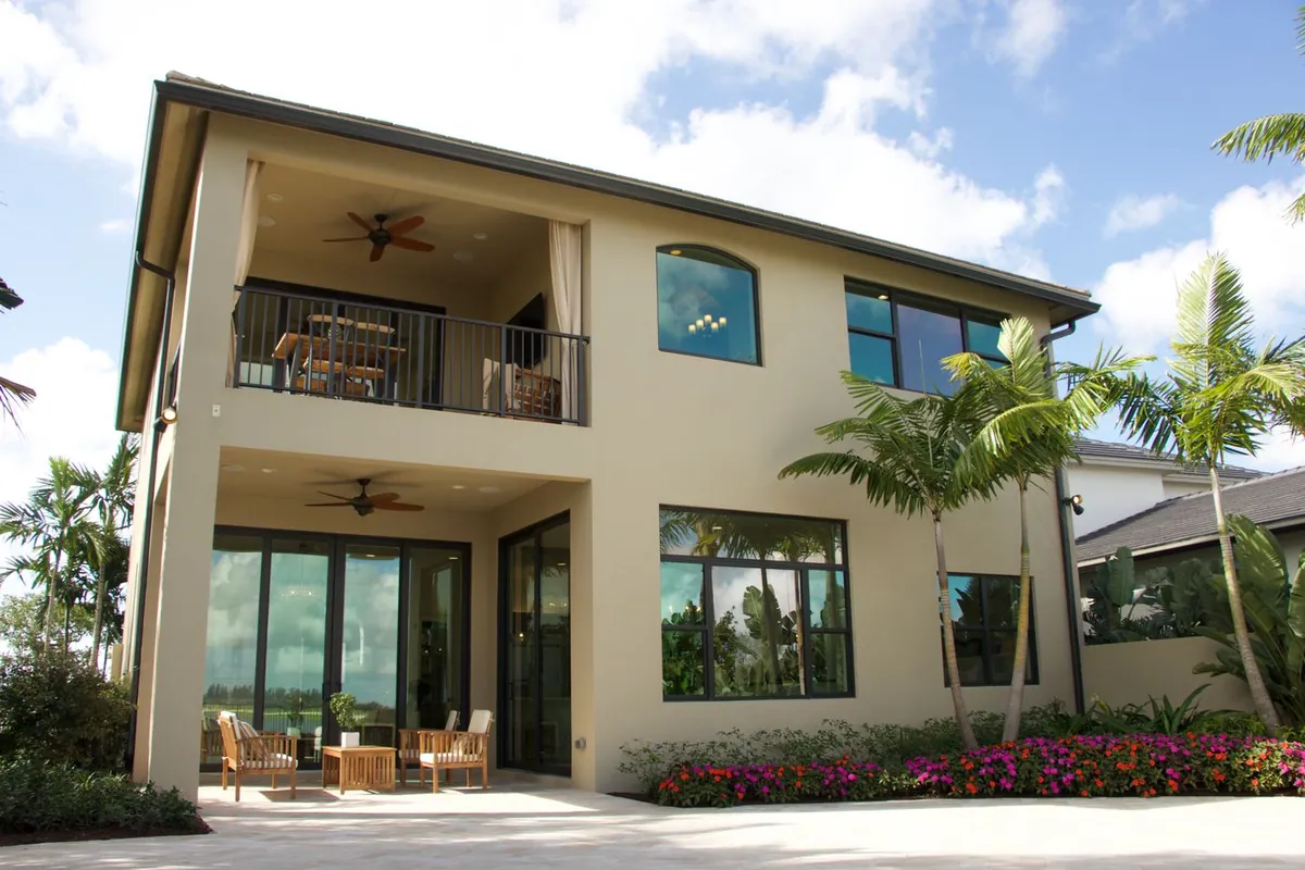 Two-story Florida home with clean stucco walls and a screened lanai